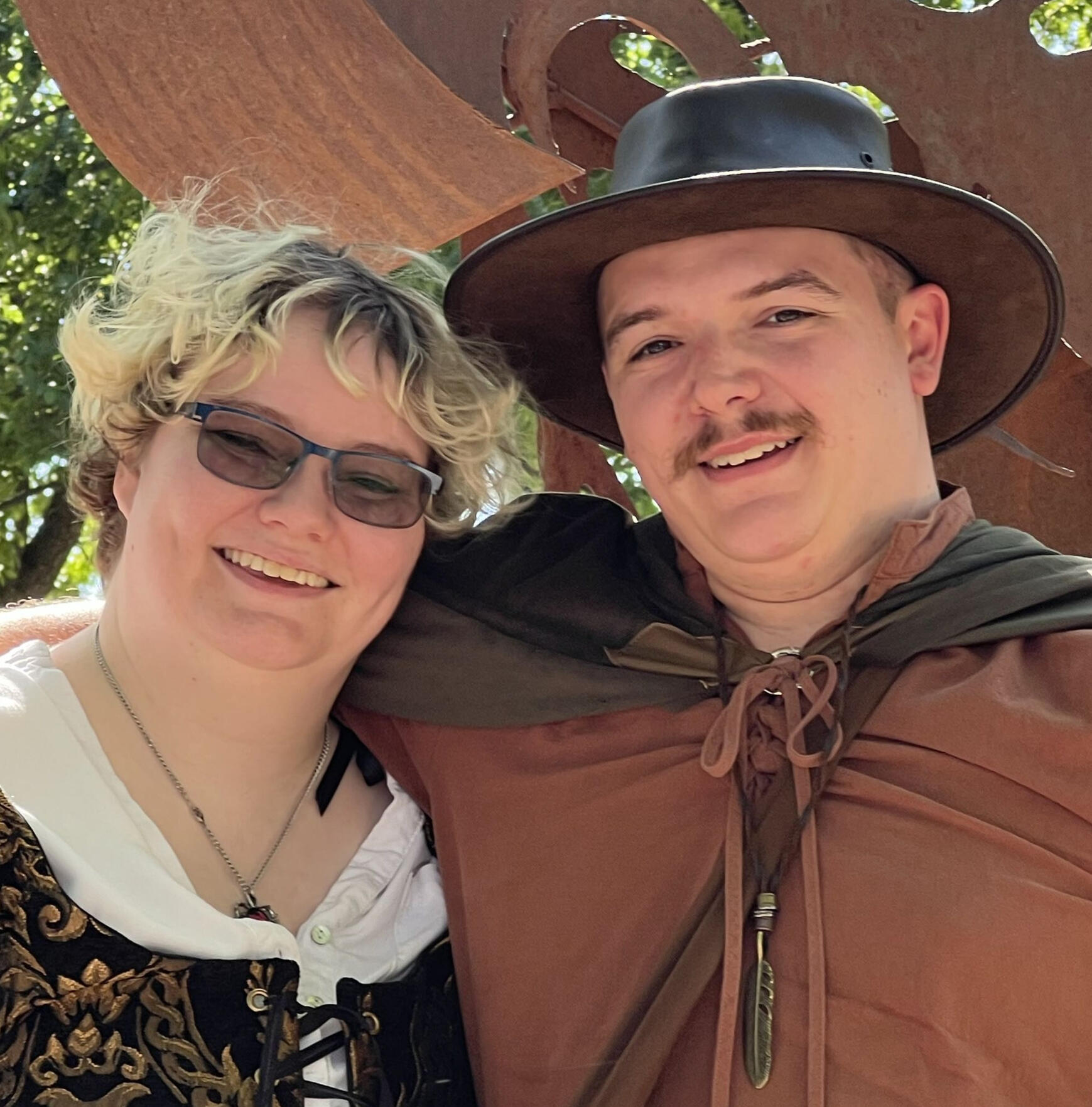 Kyle and Ryan, the people behind exopaws, smiling for a photograph at a renfaire.